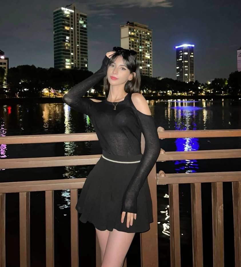Maram in black beside a river at night